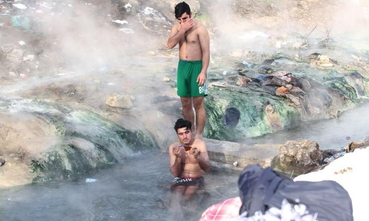 Migrants bathing at the spring in Ilidža, despite sub-zero temperature