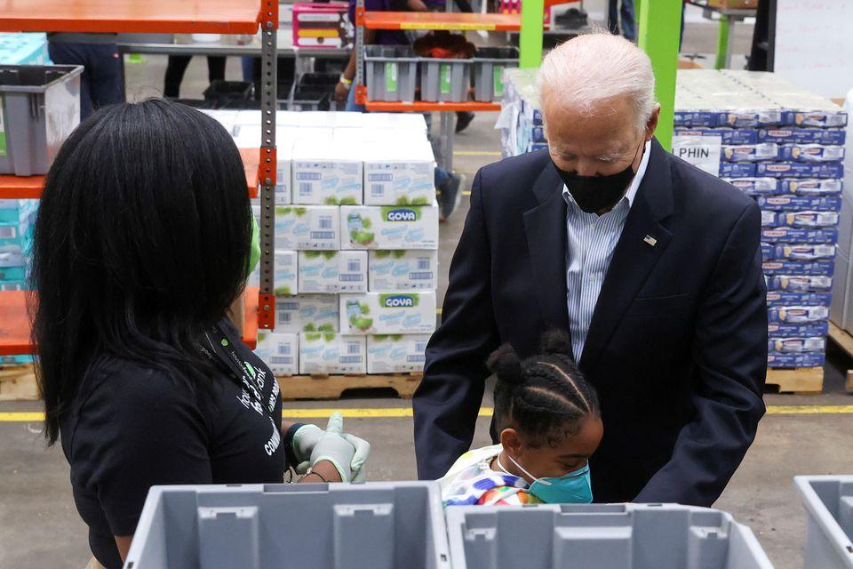 U.S. President Joe Biden hugs a child as he visits the Houston Food Bank in Houston, Texas, U.S., February 26, 2021. - Avaz