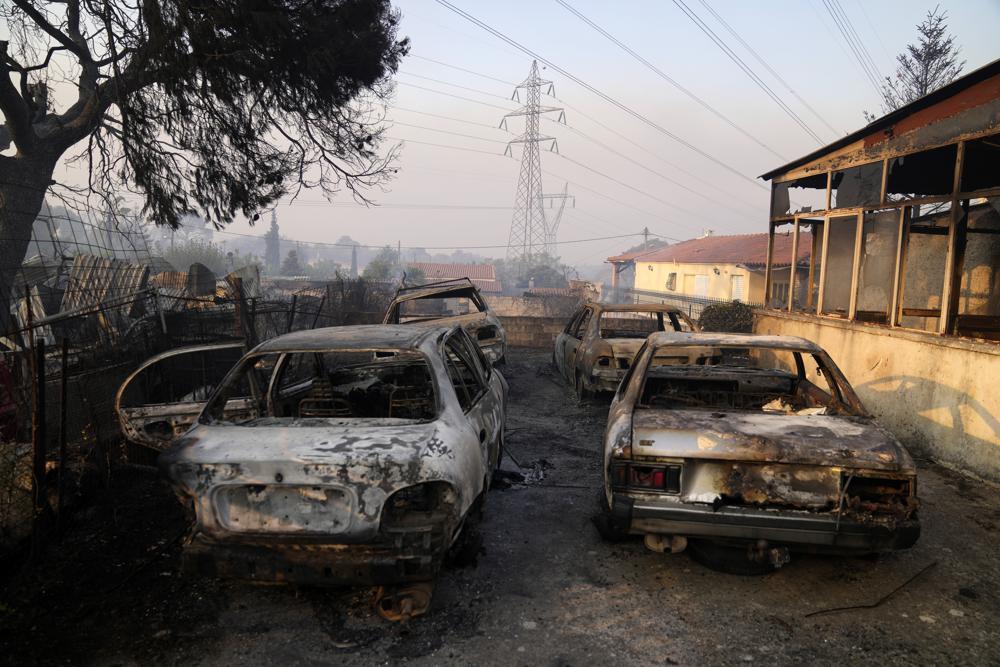 Burned cars after a wildfire in Varibobi area, northern Athens, Greece, Wednesday, Aug. 4, 2021. - Avaz