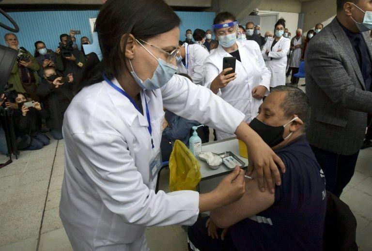 A nurse inoculates a fellow health worker against Covid-19 at a hospital in Tunisia's capital on Saturday - Avaz