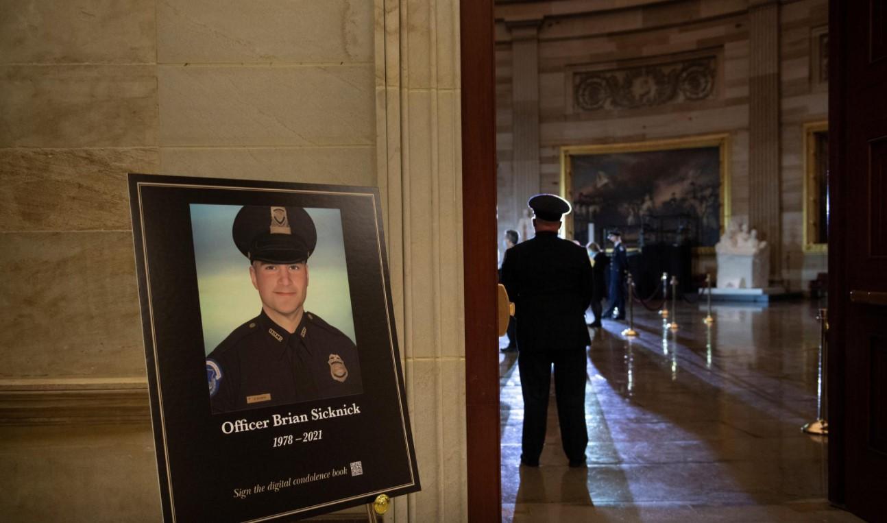 A picture of of Capitol Police officer Brian Sicknick, who died on Jan. 7 from injuries he sustained while protecting the U.S. Capitol during the Jan. 6 attack on the building, is seen as people wait for his remains to arrive to lay in honor in the Rotunda of the U.S. Capitol building in Washington, DC, U.S. February 2, 2021. - Avaz