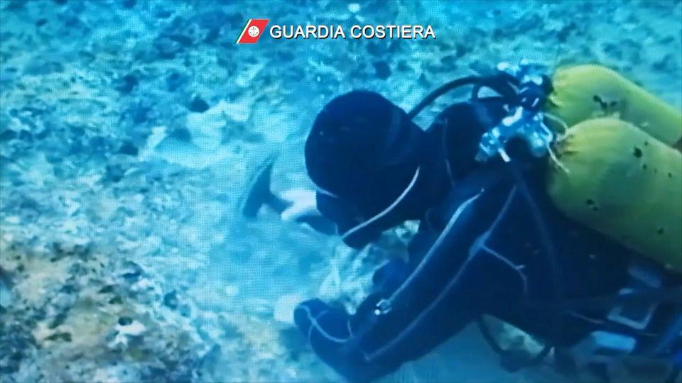 A scuba diver illegally harvests date mussels at Tyrrhenian Sea in this screengrab taken from a video released on July 28, 2021. - Avaz