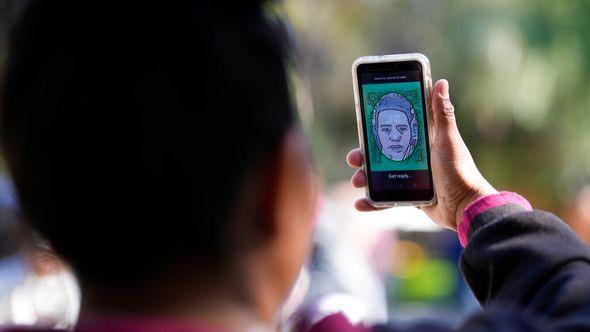A migrant from Michoacan, Mexico, uses the CBPOne app - Avaz