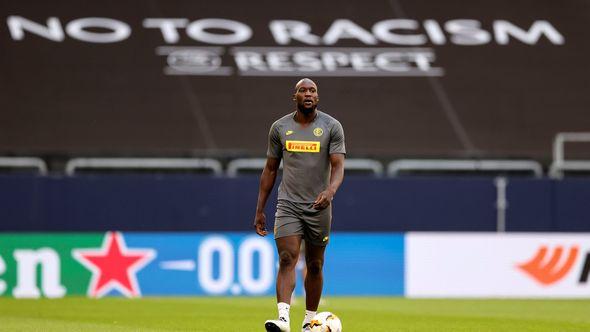 Inter Milan's Romelu Lukaku walks on the pitch in front of a 'no to racism' banner - Avaz