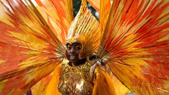 A participant in colourful costume on the first day of the Notting Hill Carnival - Avaz