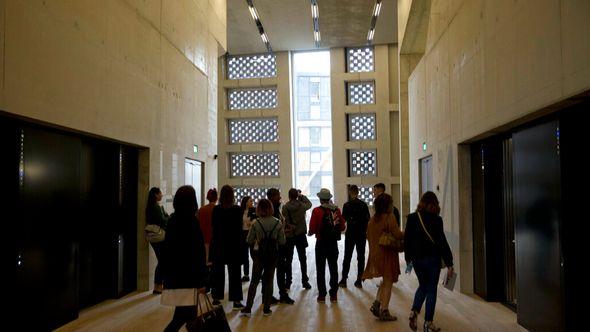 People stand in an area by the lifts in the new Switch House building extension to the Tate Modern gallery in London - Avaz