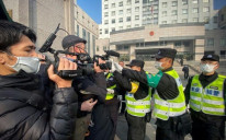 Police attempt to stop journalists from filming outside a Shanghai court where citizen journalist Zhang Zhan was tried for her early reports from Wuhan on Covid-19