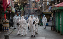 Civil servants in protective face masks and gowns enforcing a lockdown in Jordan, Hong Kong, on Jan 23, 2021.