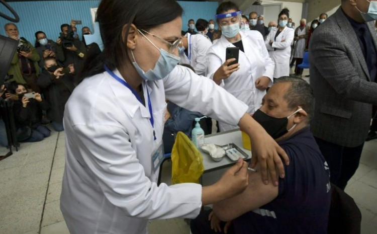 A nurse inoculates a fellow health worker against Covid-19 at a hospital in Tunisia's capital on Saturday