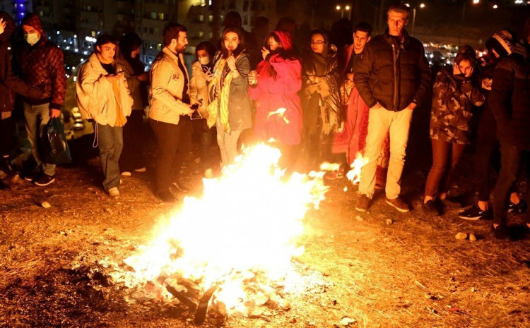 Iranian families gather round a bonfire in Tehran, ignoring a ban on gatherings in the capital, to celebrate Chaharshanbe Suri, the fire festival held in the runup to this weekend's Persian New Year 