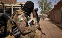 A member of the Malian Armed Forces (FAMA) patrols a road in central Mali, February 2020.