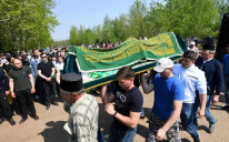 Mourners carry the casket of teacher Elvira Ignatyeva, who was killed in the shooting