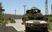 Afghan soldiers stand guard at a road checkpoint outside Bagram Air Base, after all US and NATO troops left