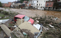 A damaged vehicle is seen next to the river, following heavy rainfalls, in Pepinster, Belgium, July 16, 2021.