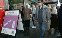Sydney residents queue outside a pharmacy for a Covid-19 vaccination. Prime Minister Scott Morrison said Australia will reopen its borders and end lockdowns when 80% of the population is fully vaccinated 